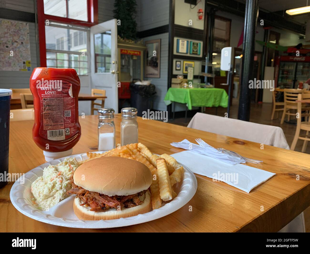 Cass, West Virginia. Lunch: Pulled Pork Sandwich, French Fries, Cole Slaw with Beverage. Stock Photo