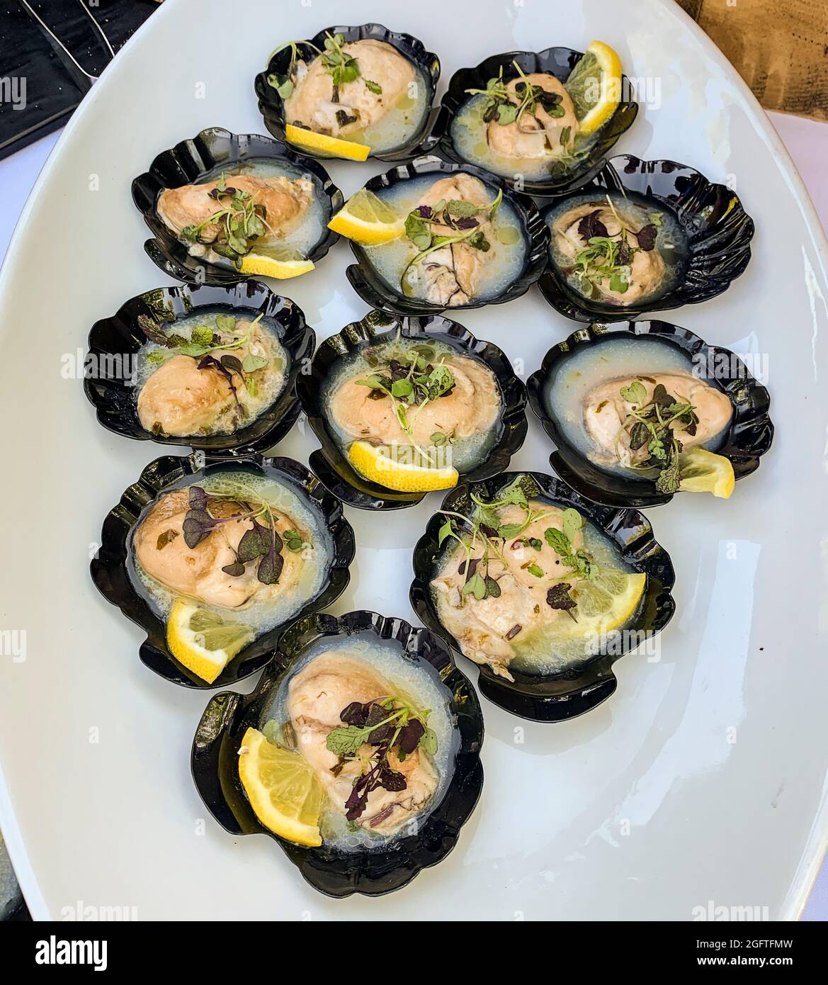 Smoked Oysters with Lemon Butter.  Hors d'oeuvres. Stock Photo