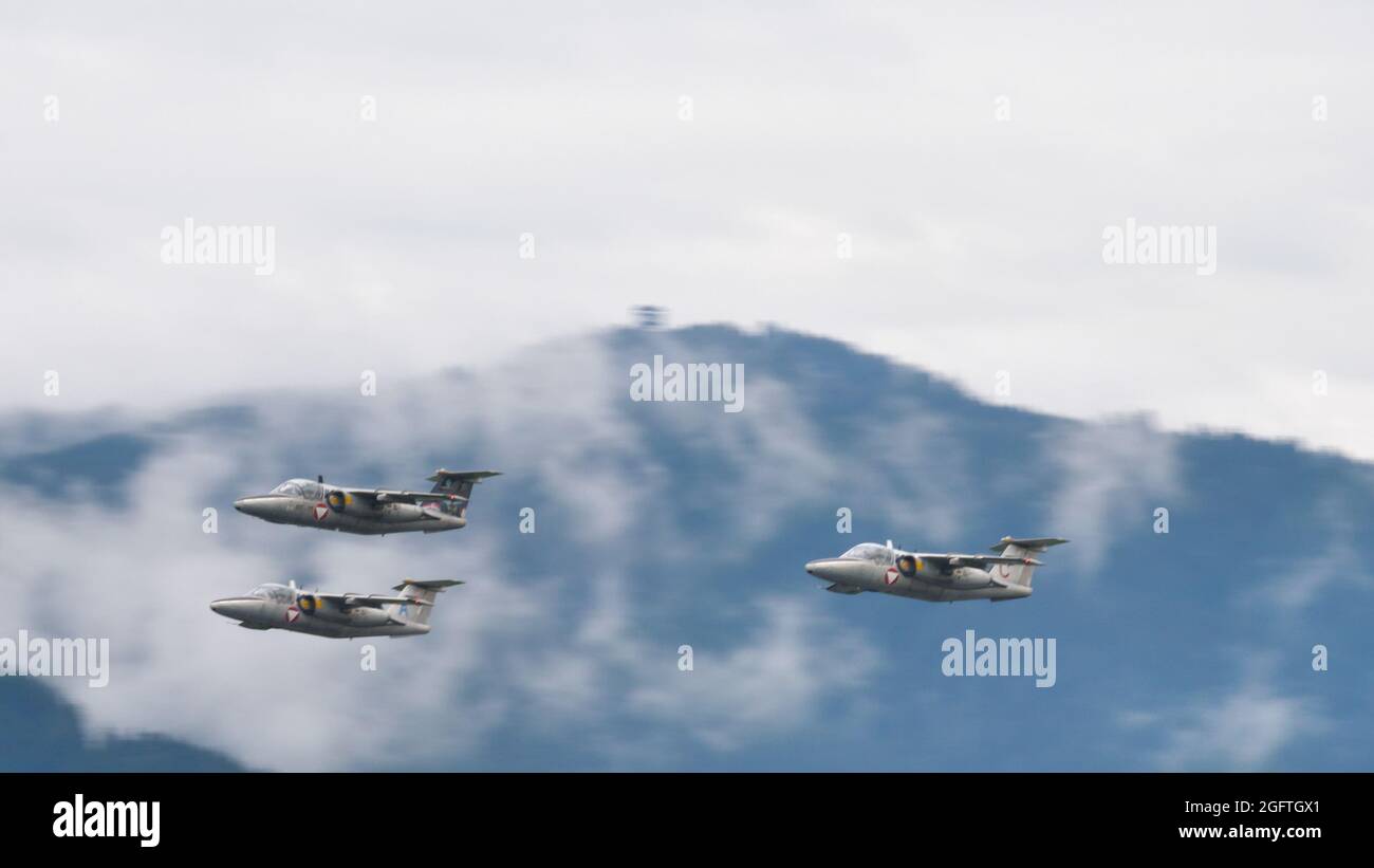 Zeltweg, Austria SEPTEMBER, 6, 2019 Formation of three military trainer aircraft in flight on a cloudy day in a green alpine valley. SAAB 105 of Austrian Air Force Stock Photo