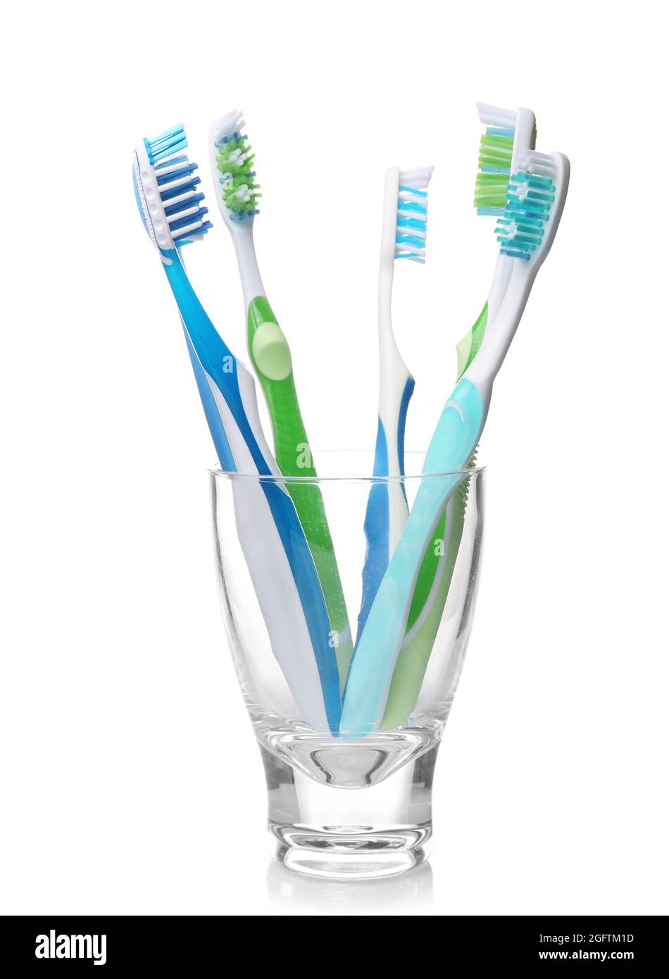 Toothbrushes in glass on white background Stock Photo - Alamy