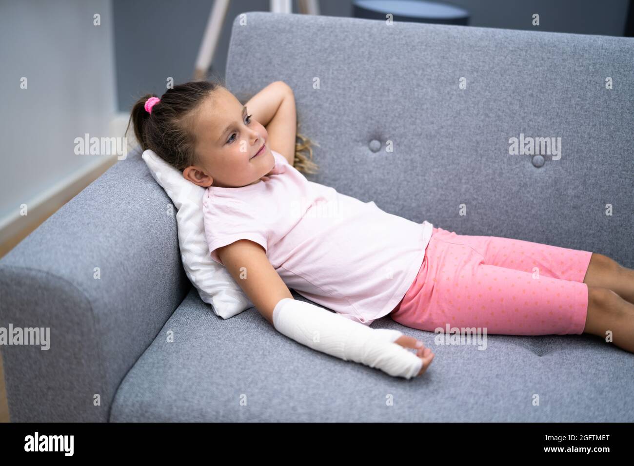 Young Child Girl With Arm Fracture And Cast Stock Photo