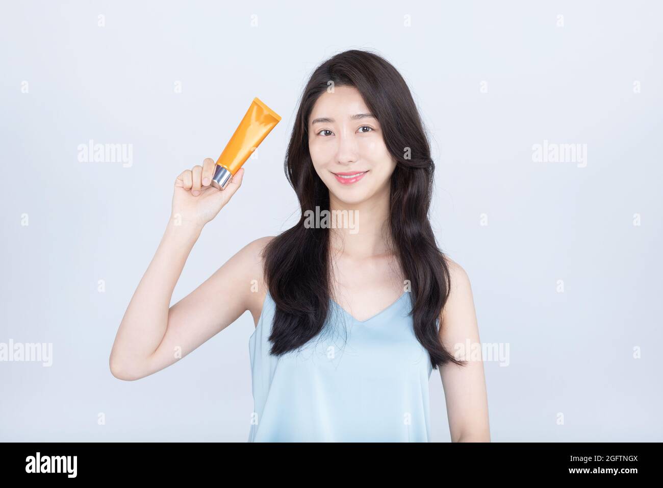 summer skincare, Asian woman with sunblock cream in white background Stock Photo