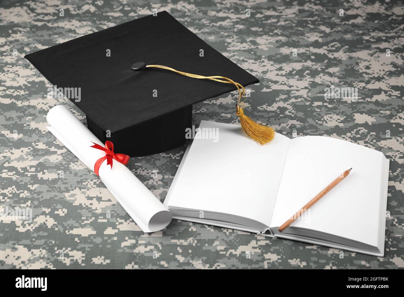 Graduation hat, diploma and book on camouflage background Stock Photo ...