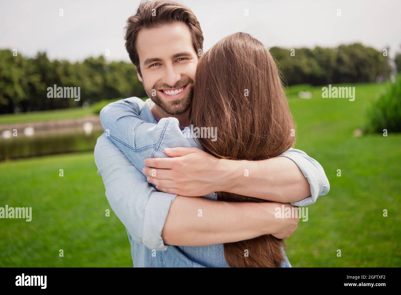 Photo of positive lovely cute beautiful couple hug embrace relaxing outdoors husband cuddle wife romantic date Stock Photo picture