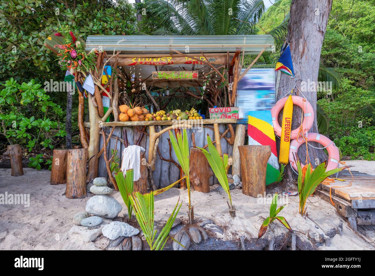 Exotic summer beach bar with mixed fruits coconut, banana and tropical fruits in Seychelles tropical island. Stock Photo