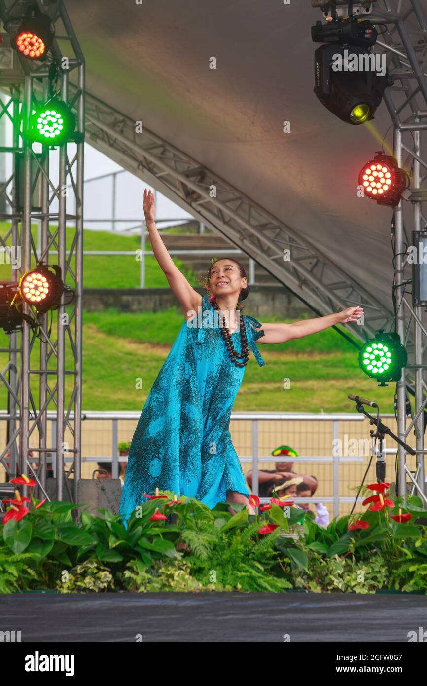 An Asian-Hawaiian woman dances on stage at Pasifika Festival, a celebration of Pacific Island culture in Auckland, New Zealand Stock Photo