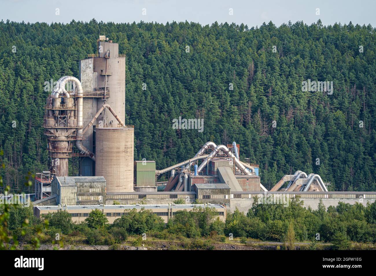 Opencast mining quarry with machinery and mining equipment. Limestone mining for cement production. Stock Photo
