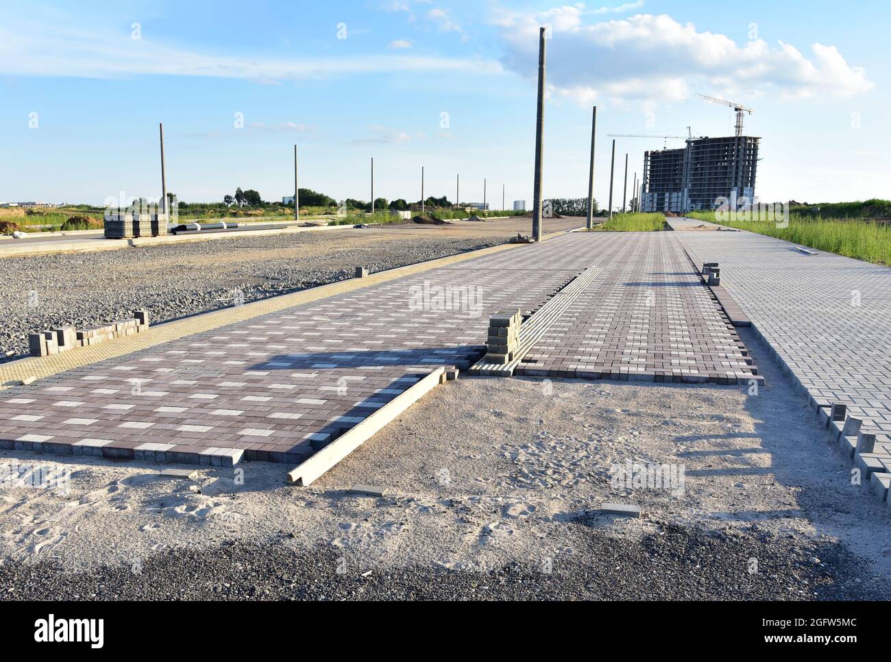 Laying paving slabs at construction site. Process of installing paving