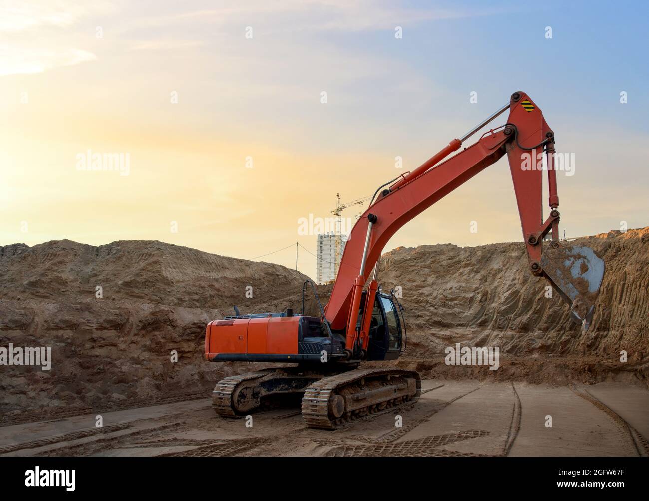 Digging the pit foundation a hole with excavator. Earthwork in