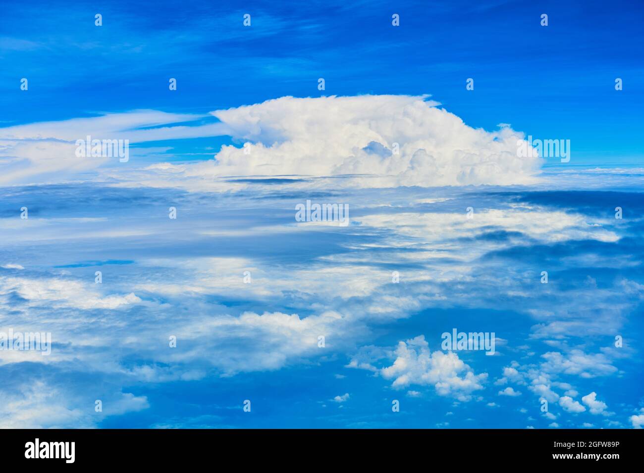 Landscape of fluffy white clouds on a dark blue sky. View from the ...