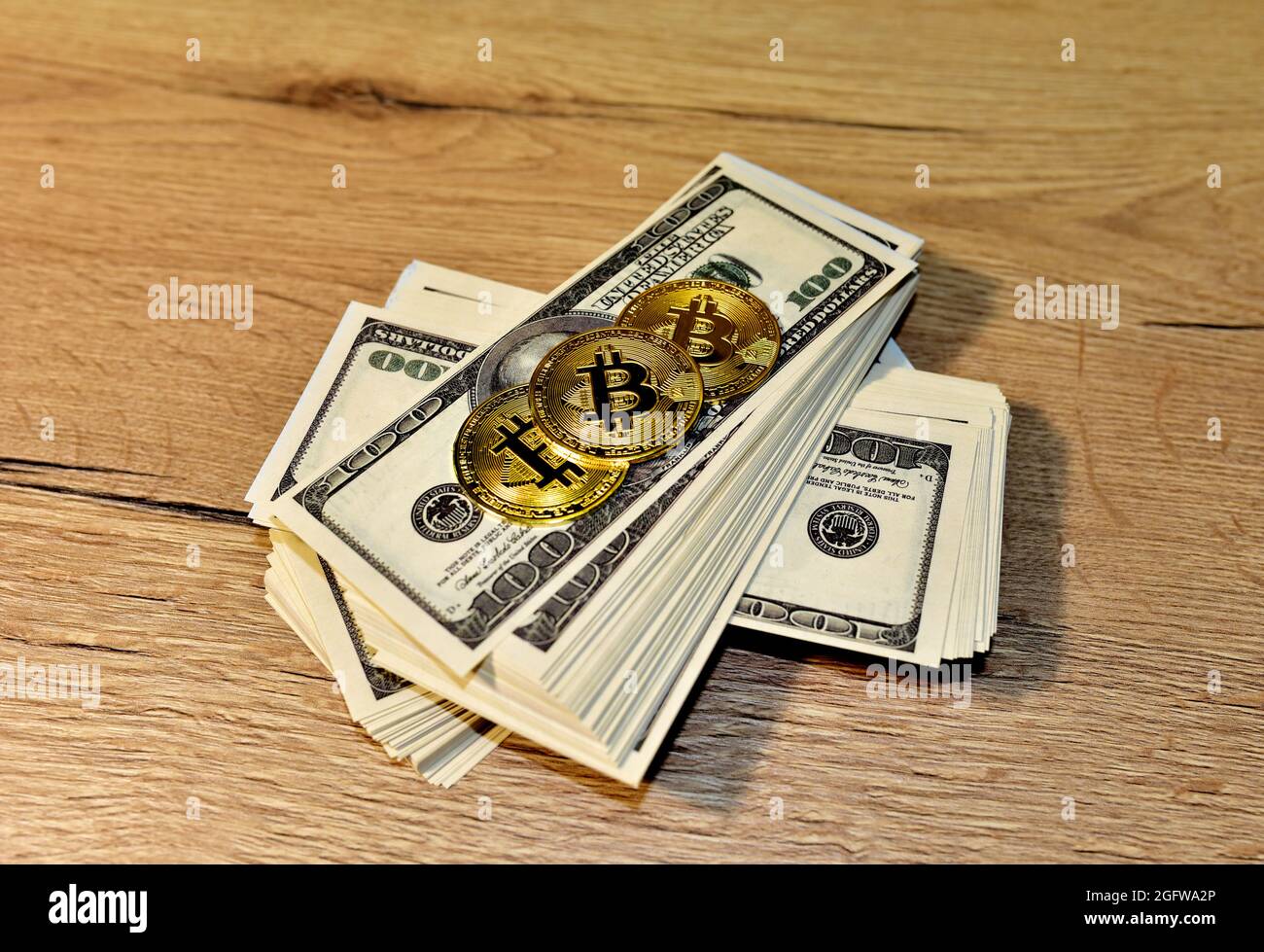 Bitcoin coins on a bundle with dollars. The concept of investing money in  cryptocurrency and making a profit due to the fall in the dollar exchange  ra Stock Photo - Alamy
