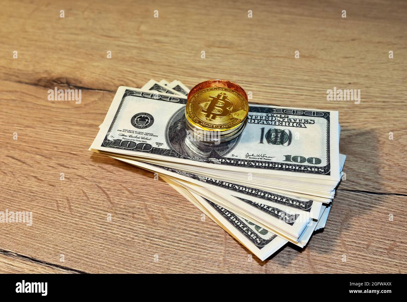 Bitcoin coins on a bundle with dollars. The concept of investing money in  cryptocurrency and making a profit due to the fall in the dollar exchange  ra Stock Photo - Alamy