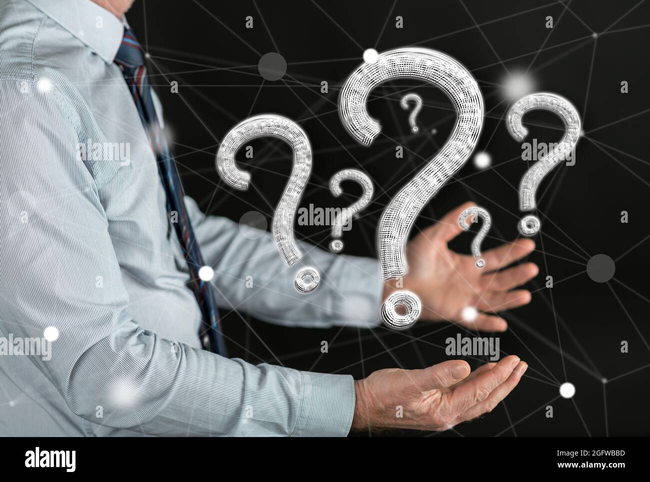 Question concept above the hands of a man Stock Photo