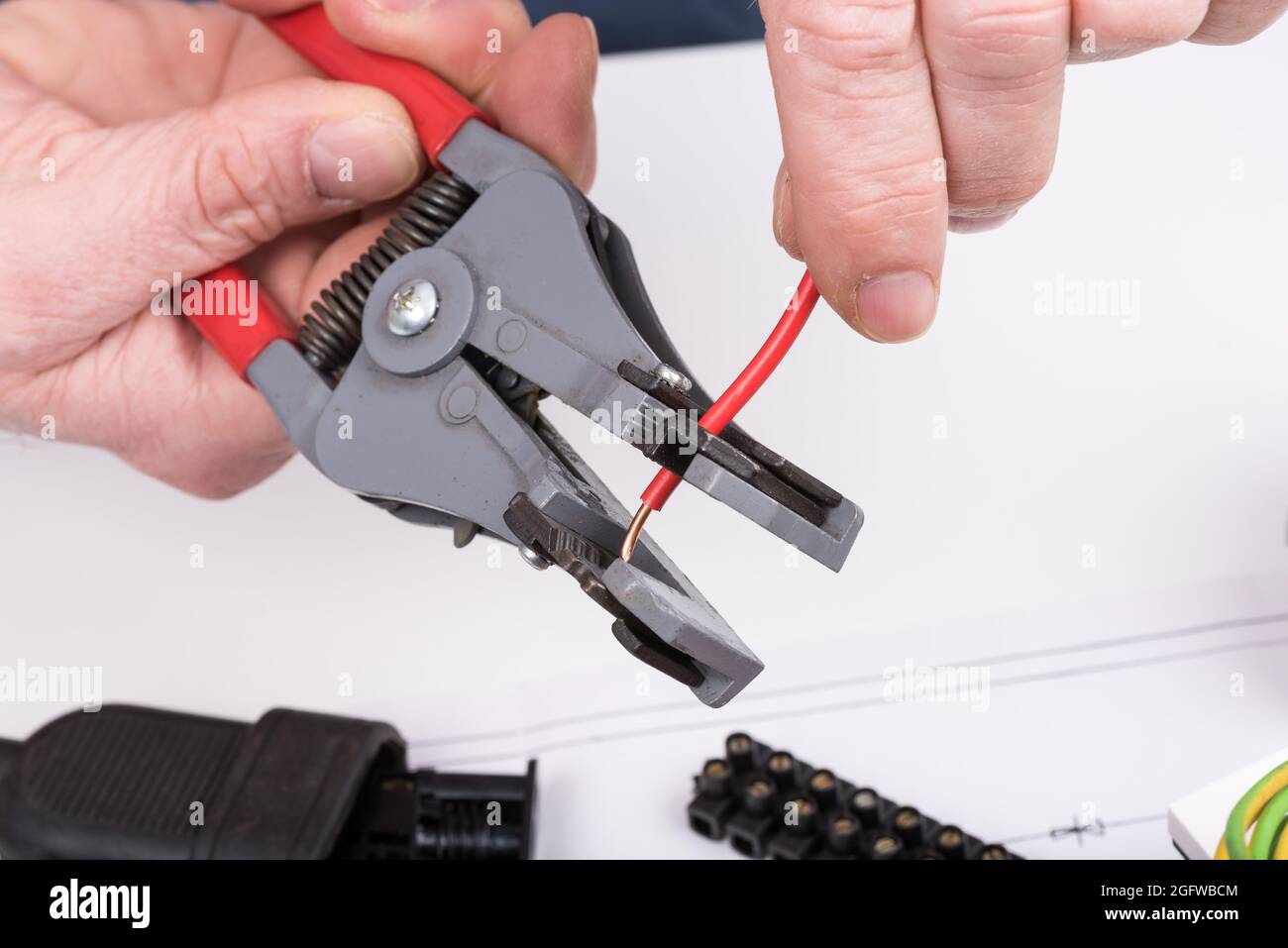 Action to strip a wire with a wire stripper, closeup Stock Photo Alamy