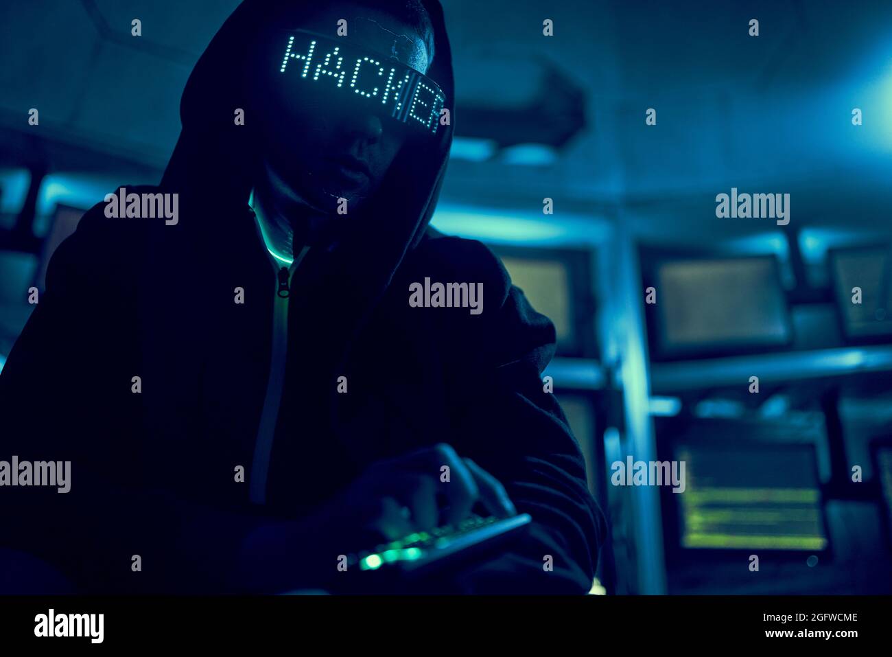 Cyber hacker breaks into databases to obtain information using a computer. Cybercrime and data security concept. Stock Photo