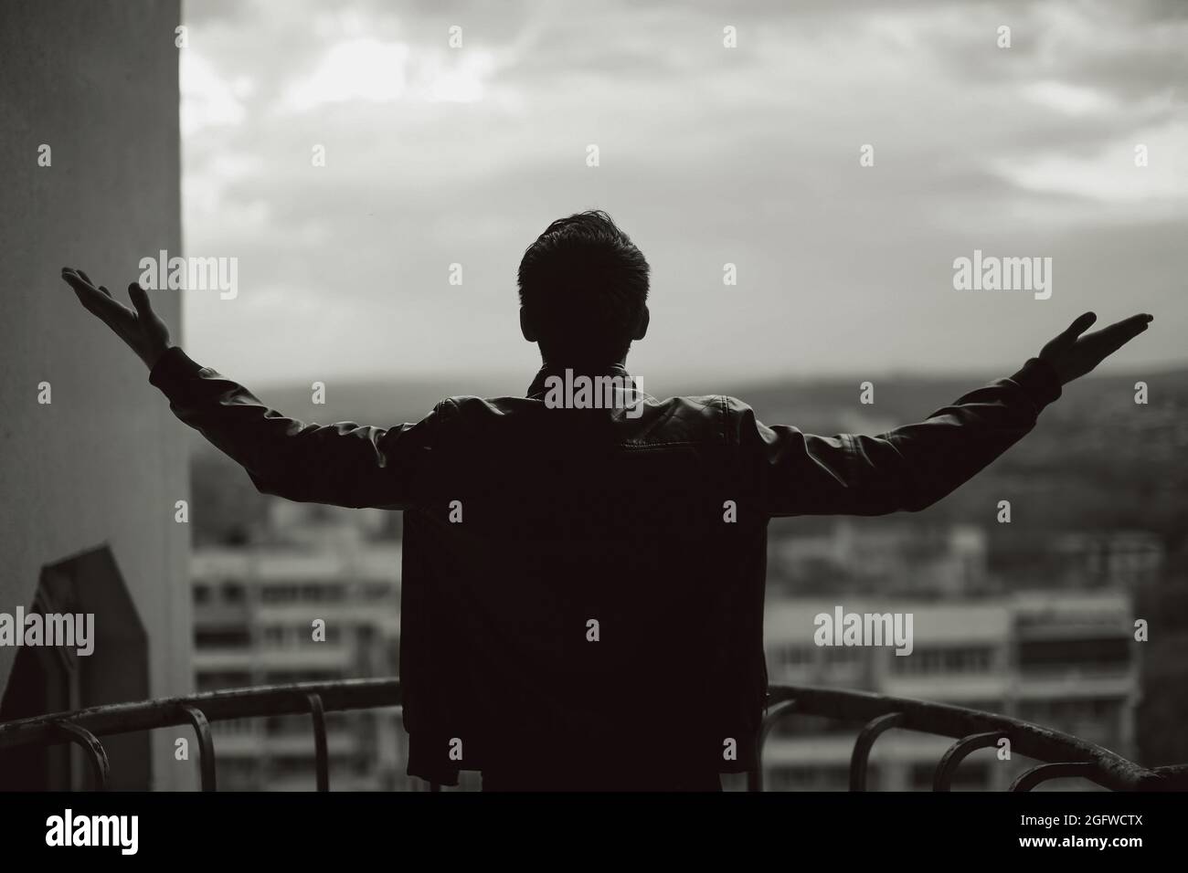 Grayscale photo of man standing near window photo – Free Cloud