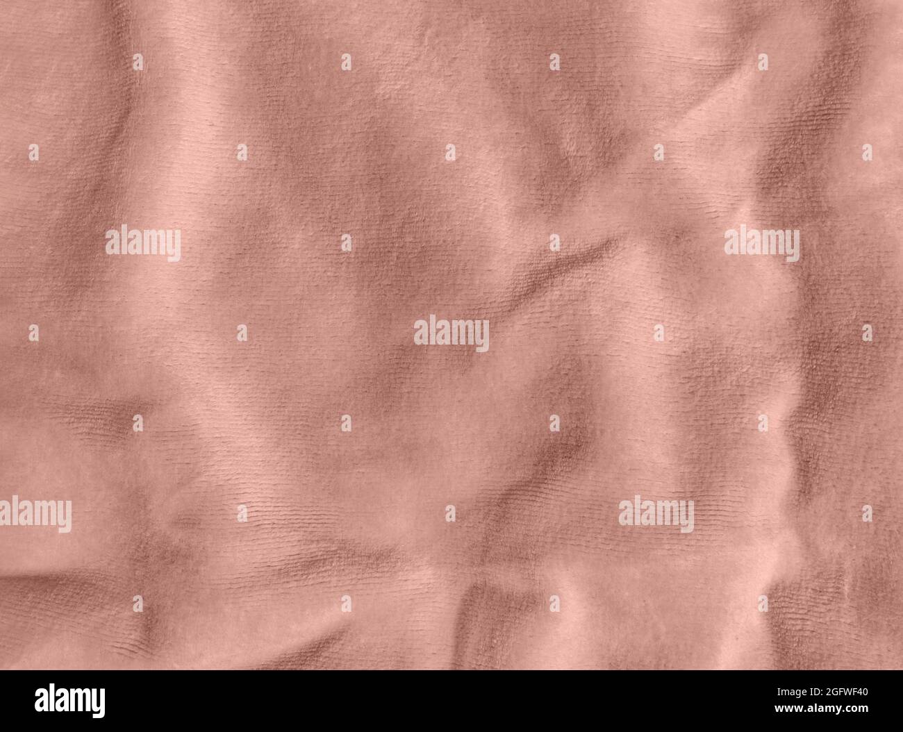 Rose gold color velvet fabric texture top view. Female blog pink velour background. Smooth soft