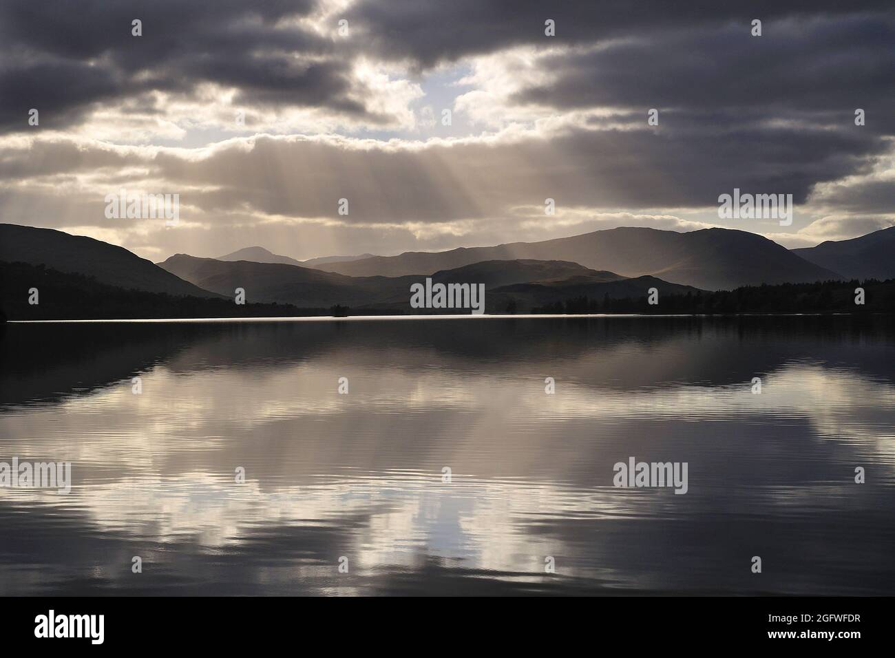Sunrays and backlit clouds over Loch Tulla, Rannoch Moor, Scottish Highlands, United Kingdom, Scotland, Perthshire, Rannoch Moor Stock Photo