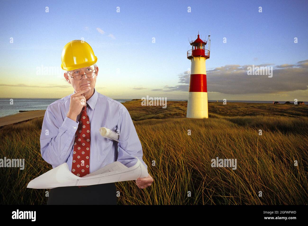 architect with construction plan and hard hat, List-East lighthouse in the background , Germany, Schleswig-Holstein, Sylt, List Stock Photo