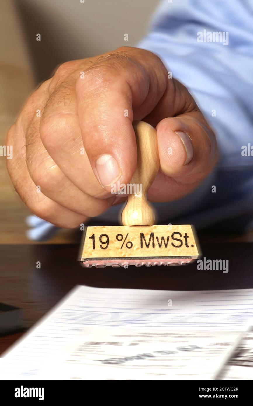 hand with rubber-stamp lettering 19% MwST, sales tax 19%, Germany Stock Photo