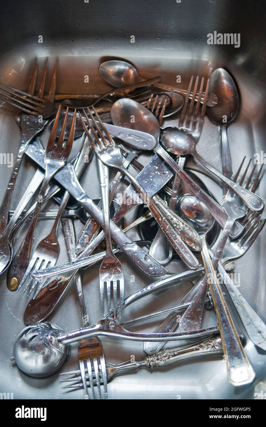 Sink with cutlery ready to be washed Stock Photo Alamy
