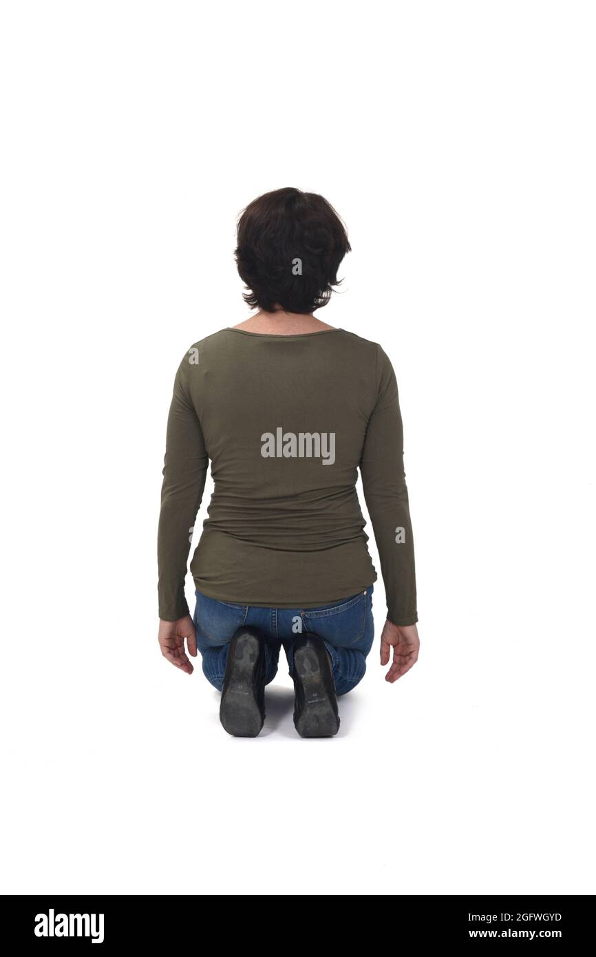 rear view of a woman kneeling on white background Stock Photo