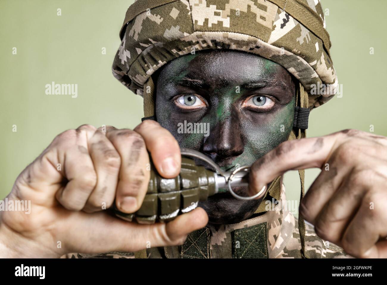 Close up view of soldier pulling safety pin out of fragmentation