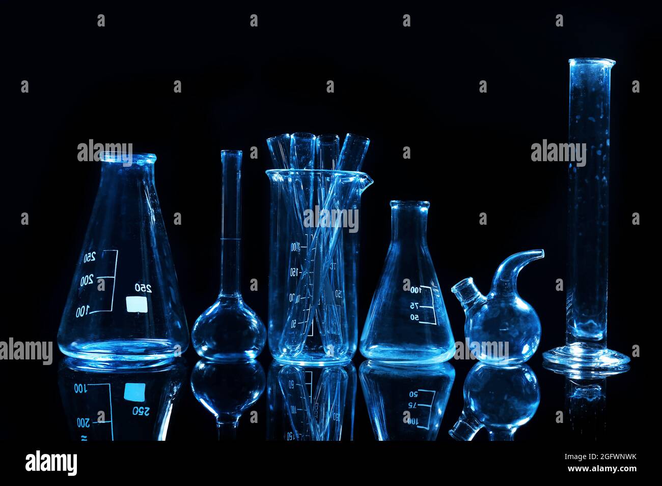 Test tubes and flasks on dark background Stock Photo - Alamy