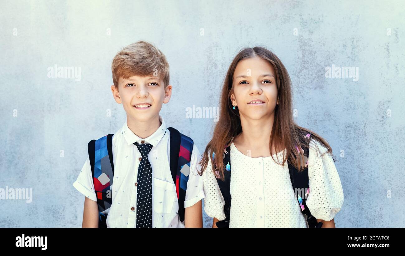 Portrait of happy school kids with backpack Stock Photo
