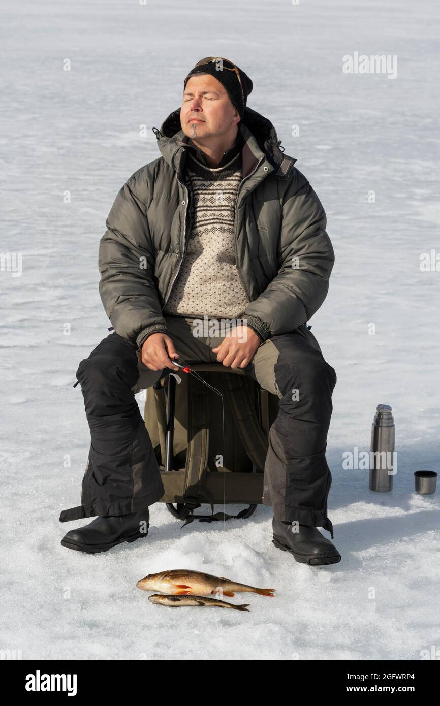 Ice fisherman sitting on bucket hi-res stock photography and images - Alamy