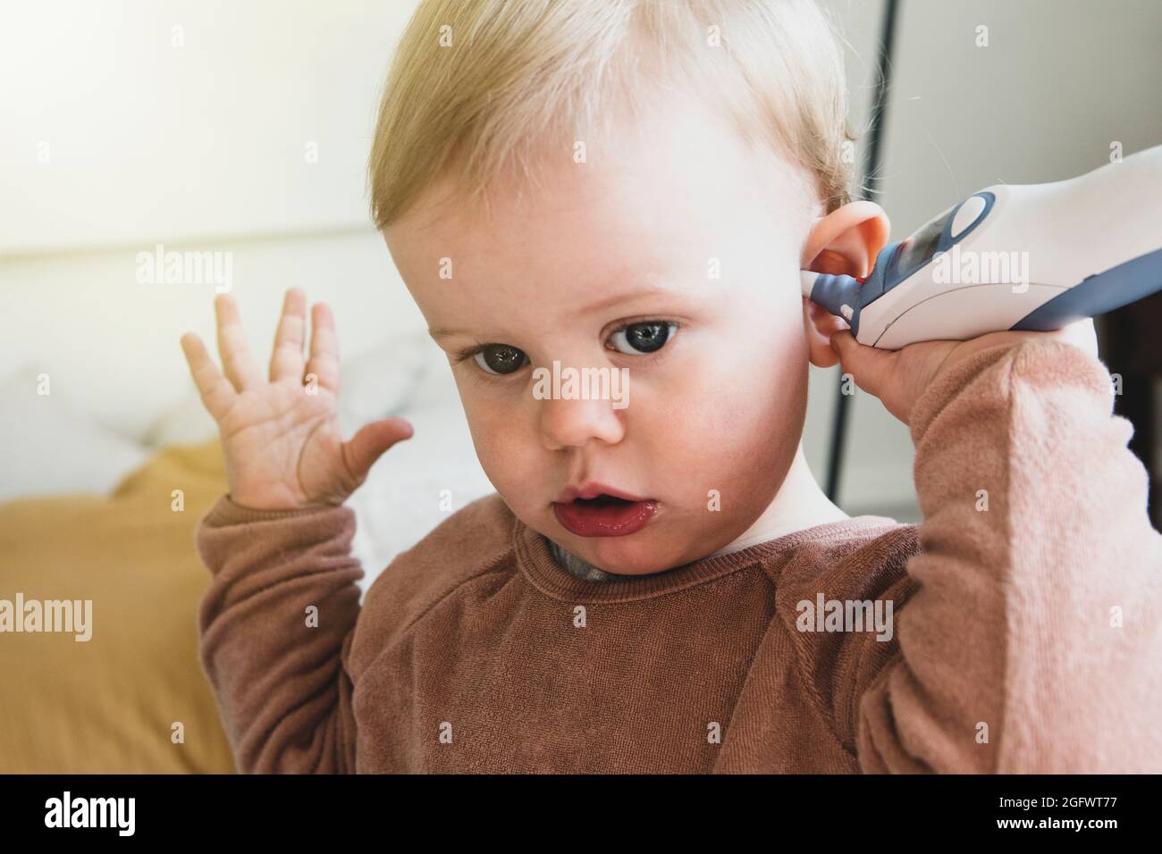 Toddler checking temperature with digital thermometer Stock Photo Alamy