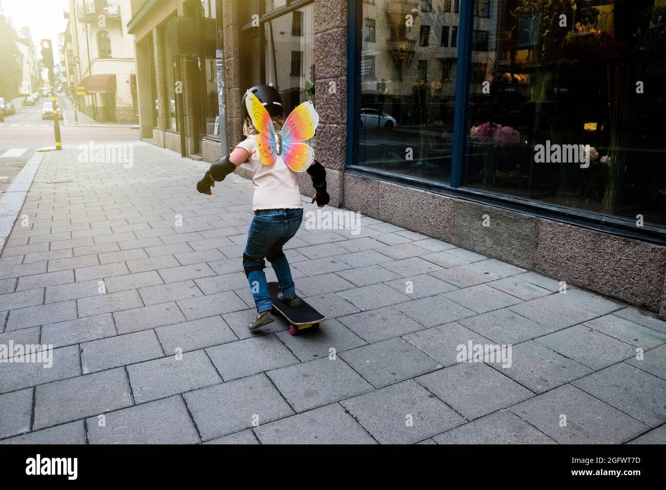 Girl skateboarding on sidewalk Stock Photo Alamy