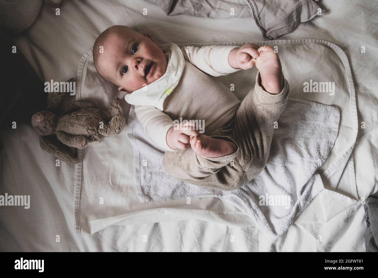 High angle view of baby lying on bed Stock Photo