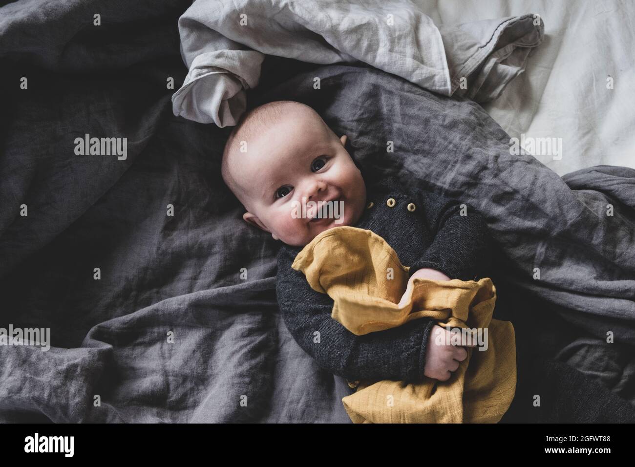 High angle view of baby lying on bed Stock Photo