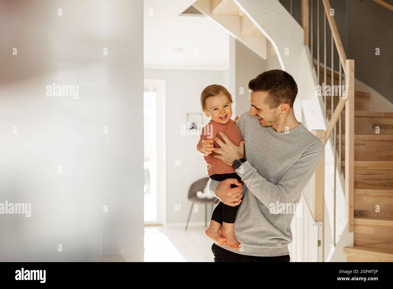Father carrying toddler daughter Stock Photo Alamy