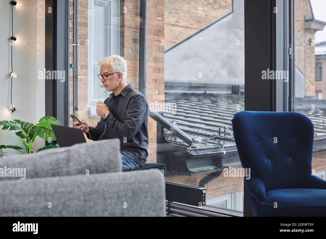 Businessman using laptop and smartphone Stock Photo
