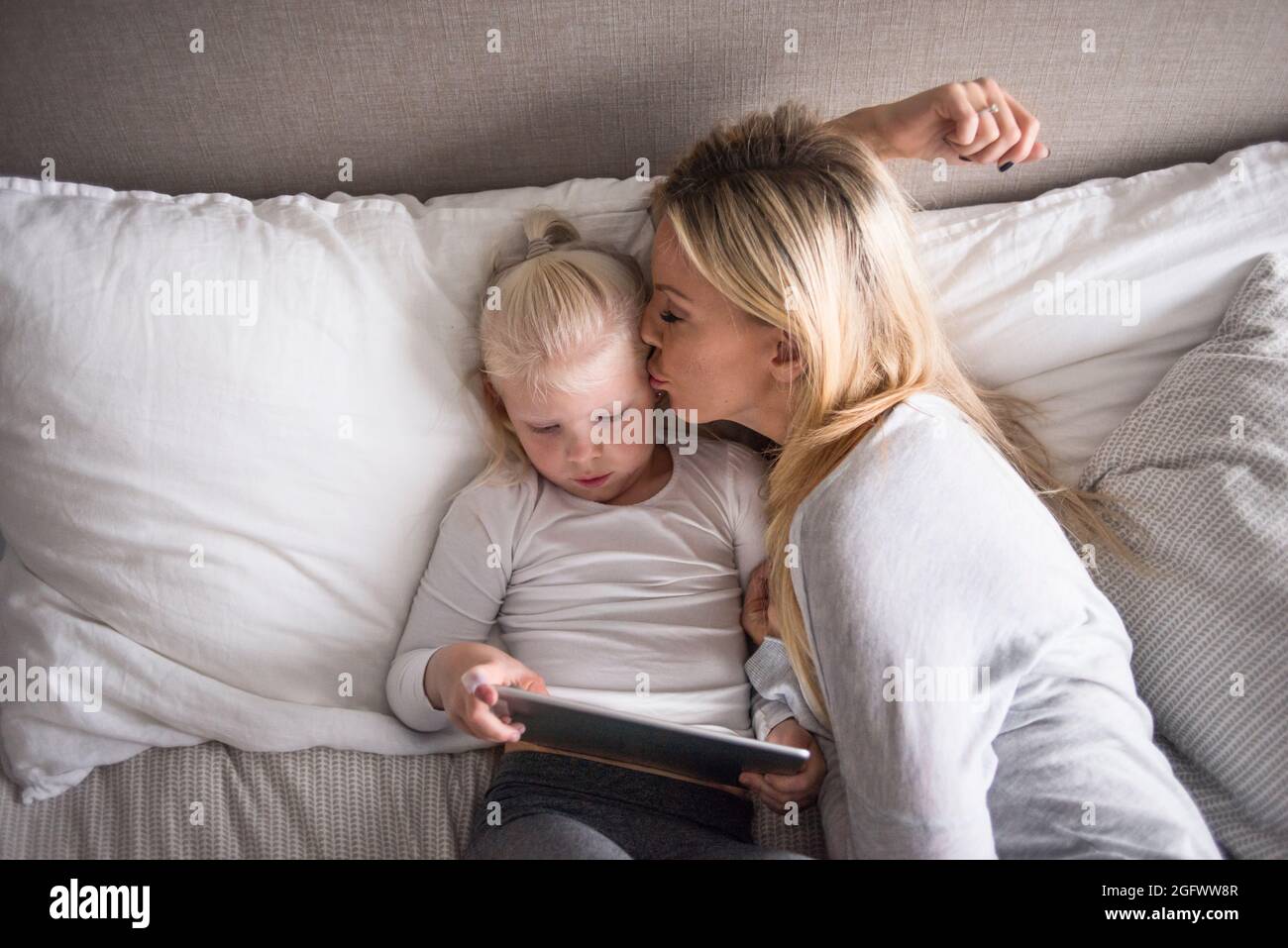 Mother and daughter using tablet in bed Stock Photo Alamy