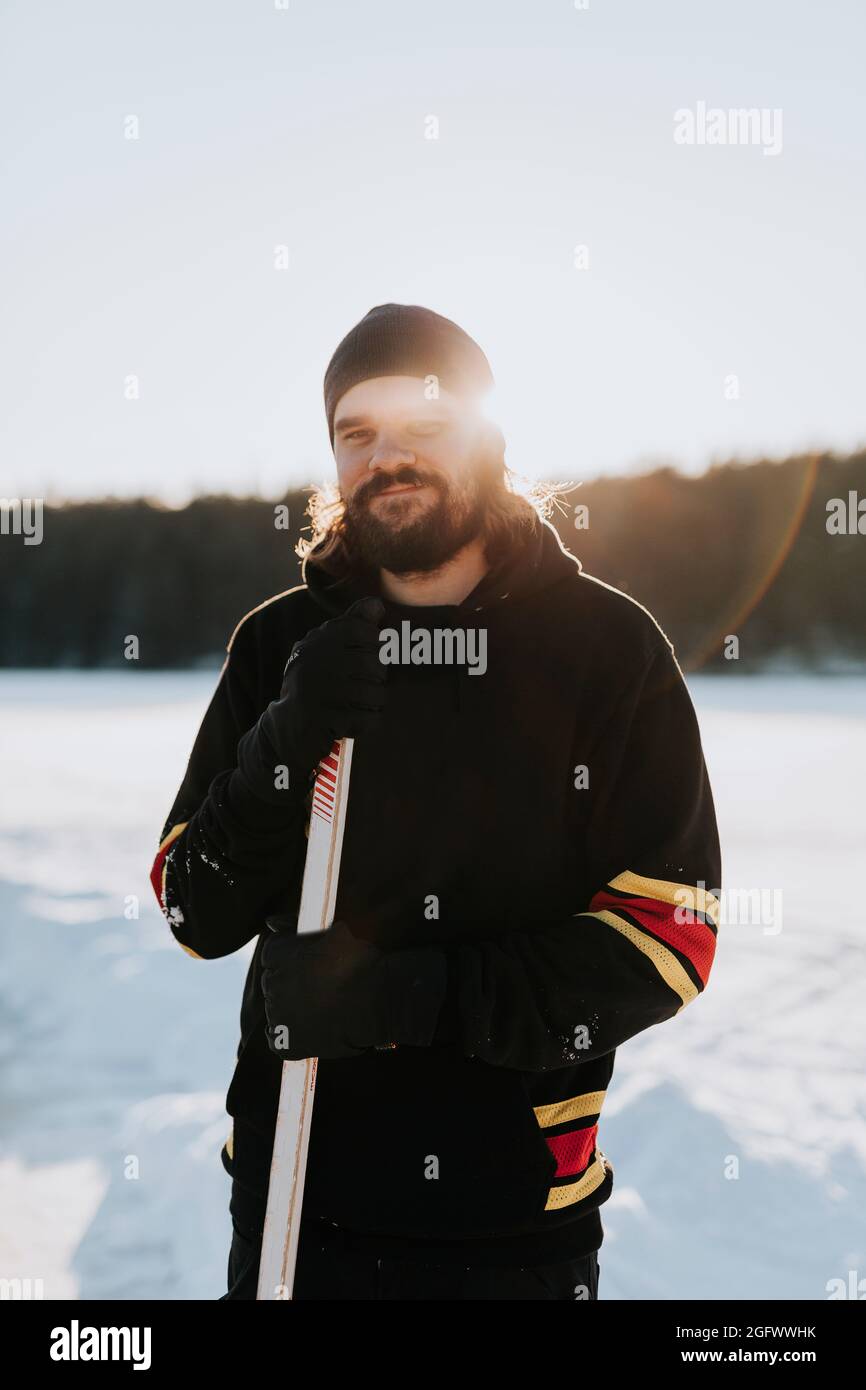Man standing on frozen lake Stock Photo