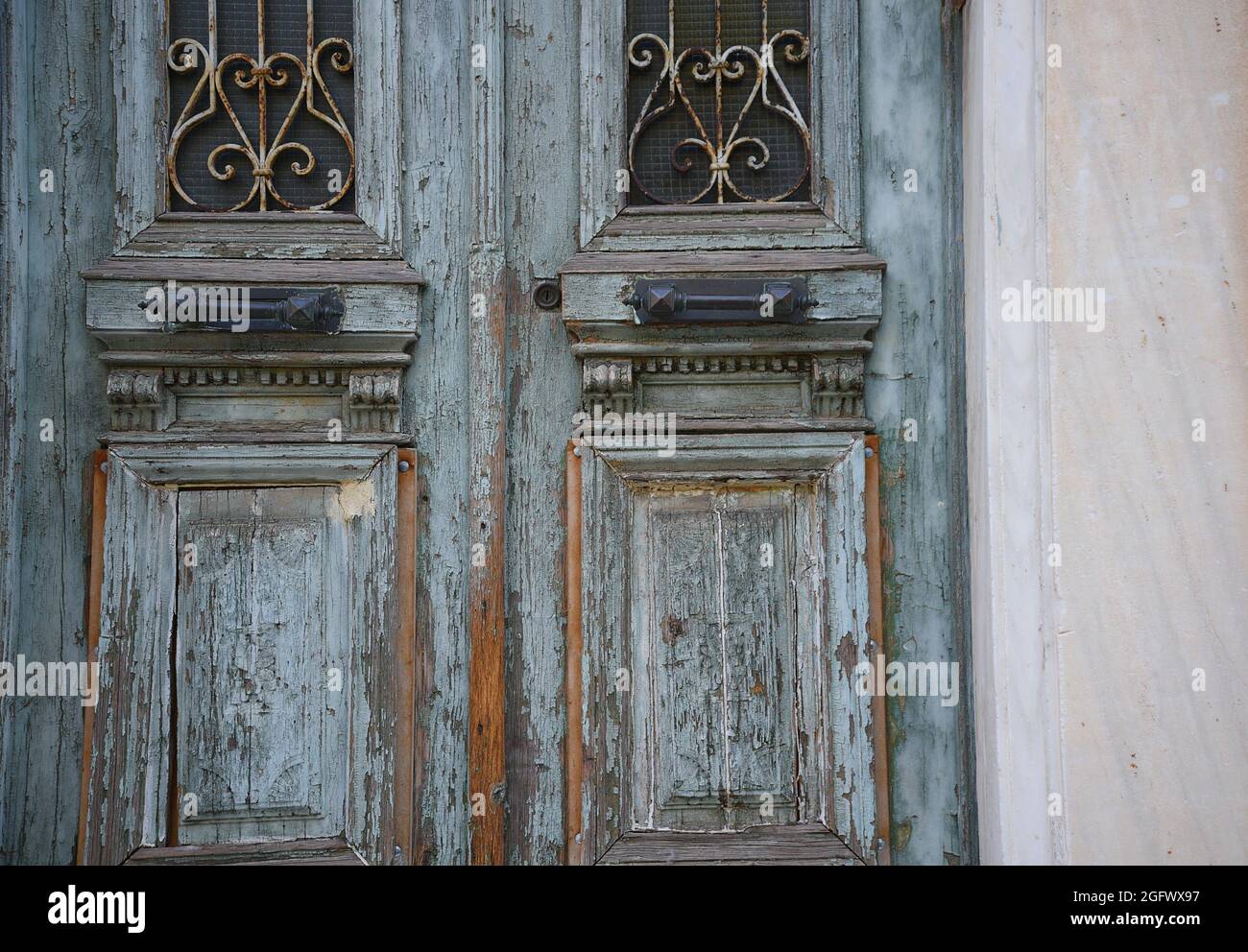 Old Neoclassical house weathered wooden entrance door with antique