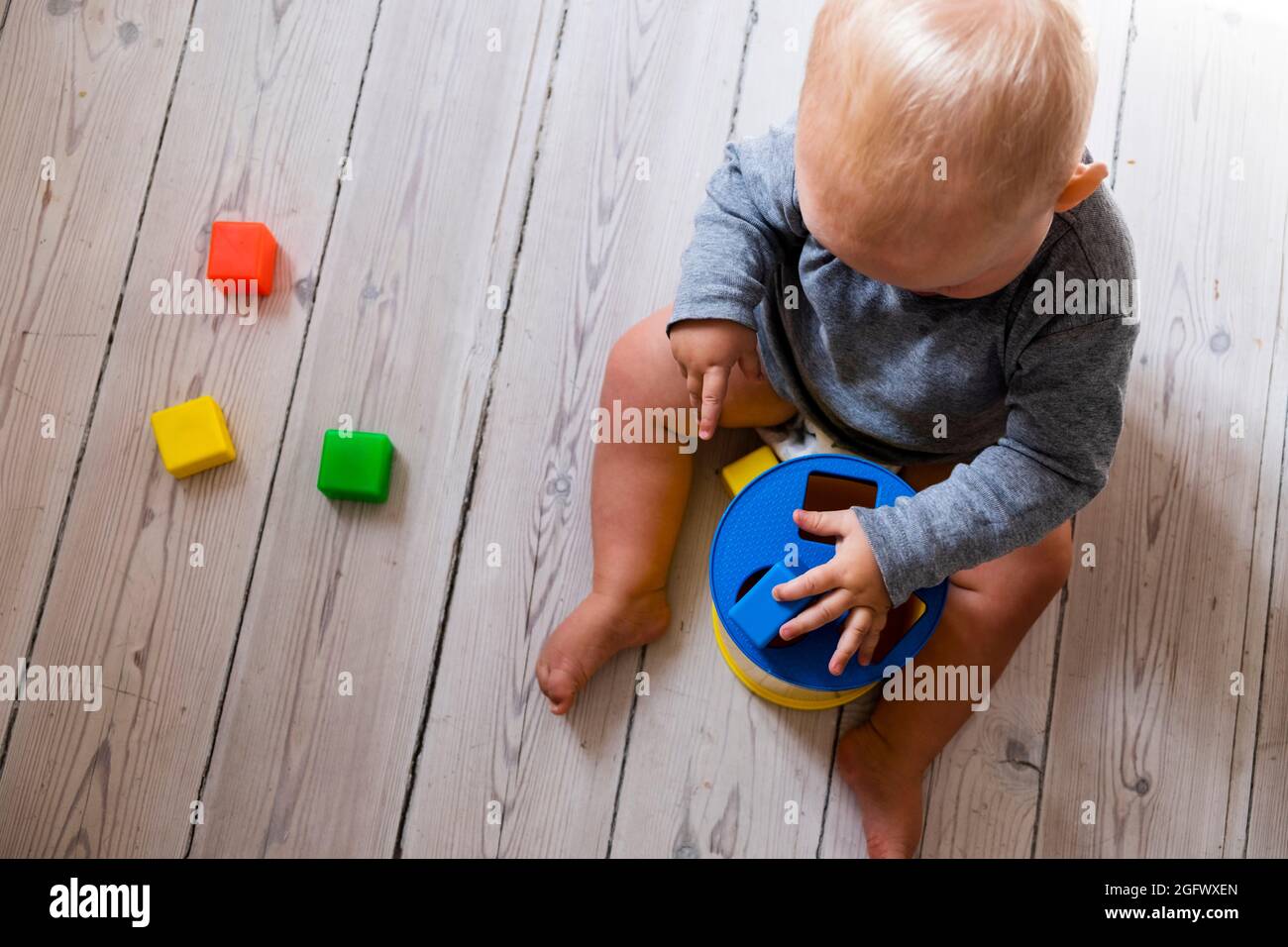 Baby boy playing in room Stock Photo