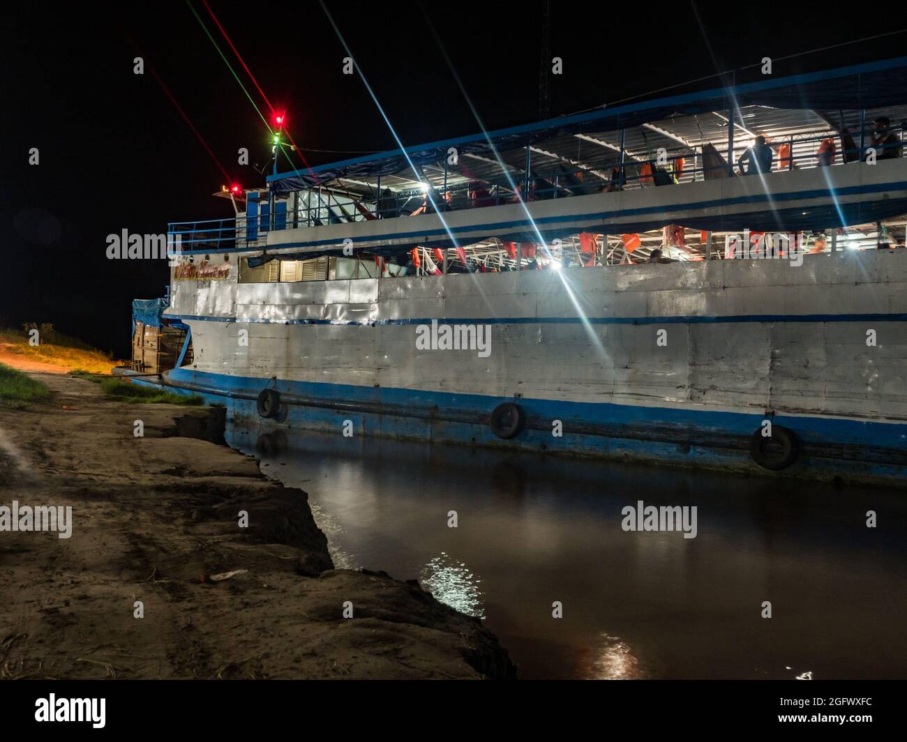 Santa Rosa, Peru - Dec, 2018: Cargo boat waiting at the port. on Amazon River during the night time. Amazonia. Latin America. Stock Photo