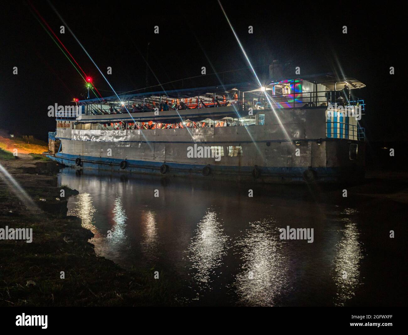 Santa Rosa, Peru - Dec, 2018: Cargo boat waiting at the port. on Amazon River during the night time. Amazonia. Latin America. Stock Photo