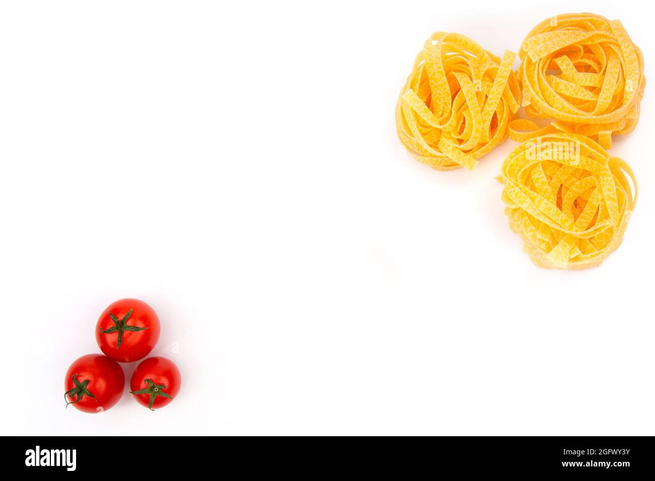 Raw Pasta with ingredients on white background. Top view Stock Photo ...