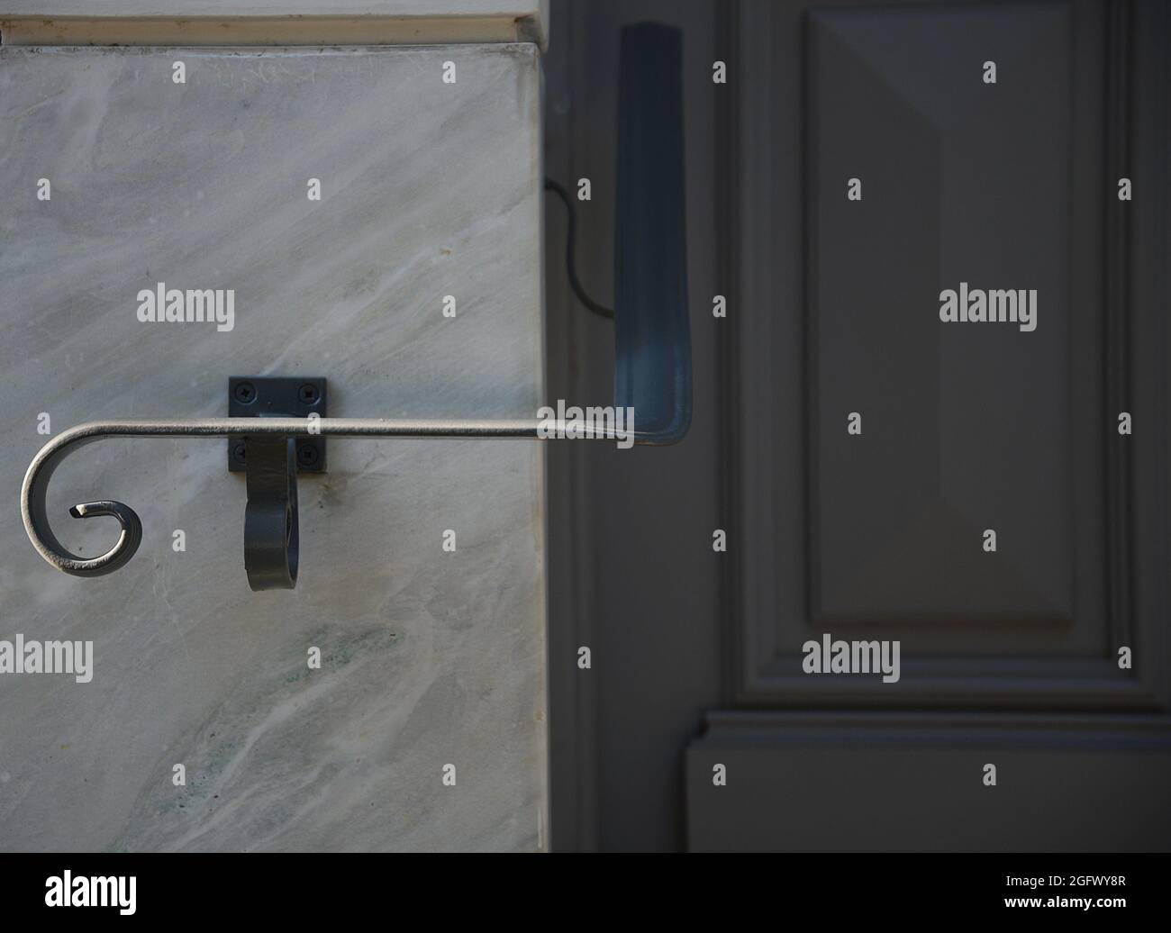 Traditional house grey wooden entrance door with a white marble trim