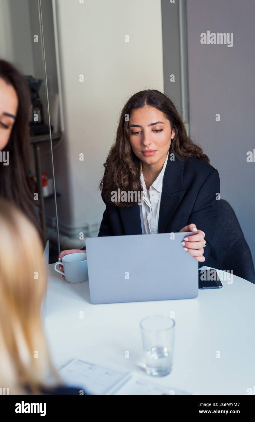 Woman using laptop in office Stock Photo