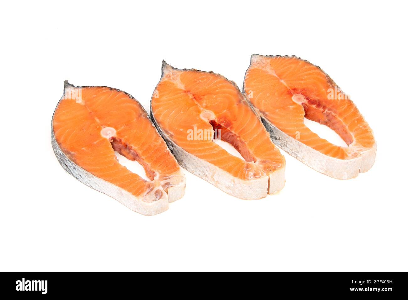 Raw salmon fish steak on a white background Stock Photo - Alamy