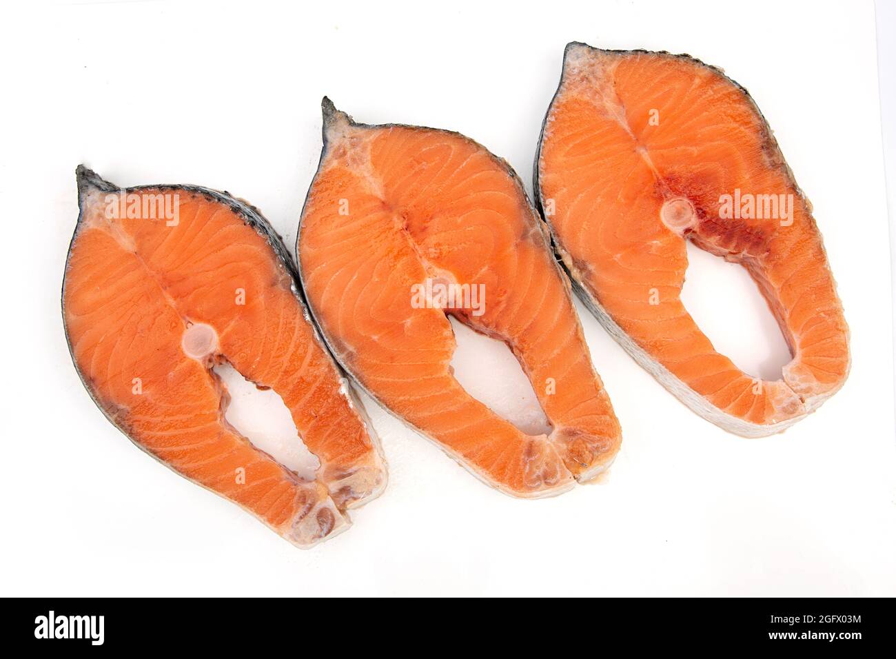 Raw salmon fish steak on a white background Stock Photo - Alamy