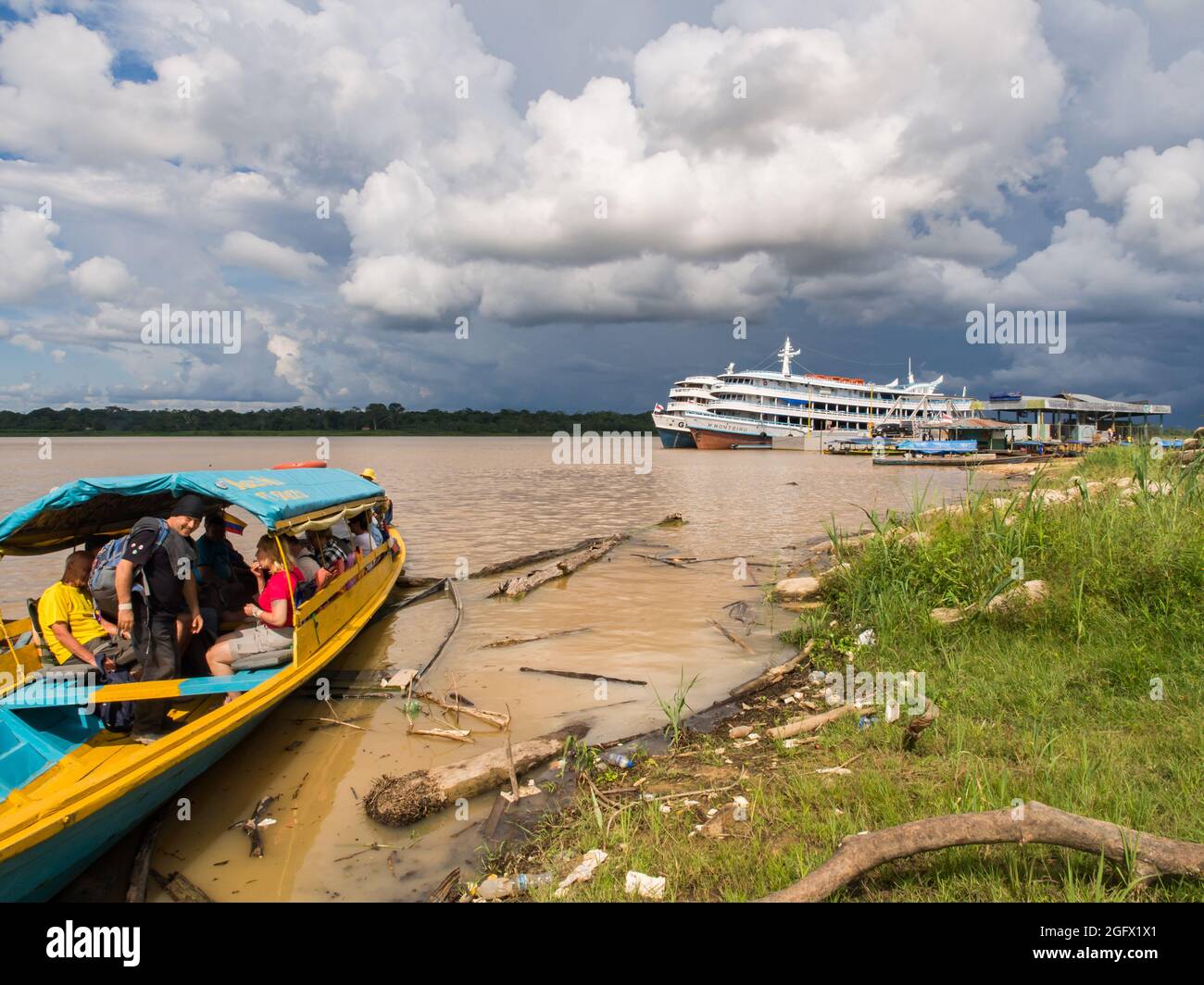 Benjamin Constant, Brazil Dec, 2017 Big, passenger boat and small wooden boats in the Amazon