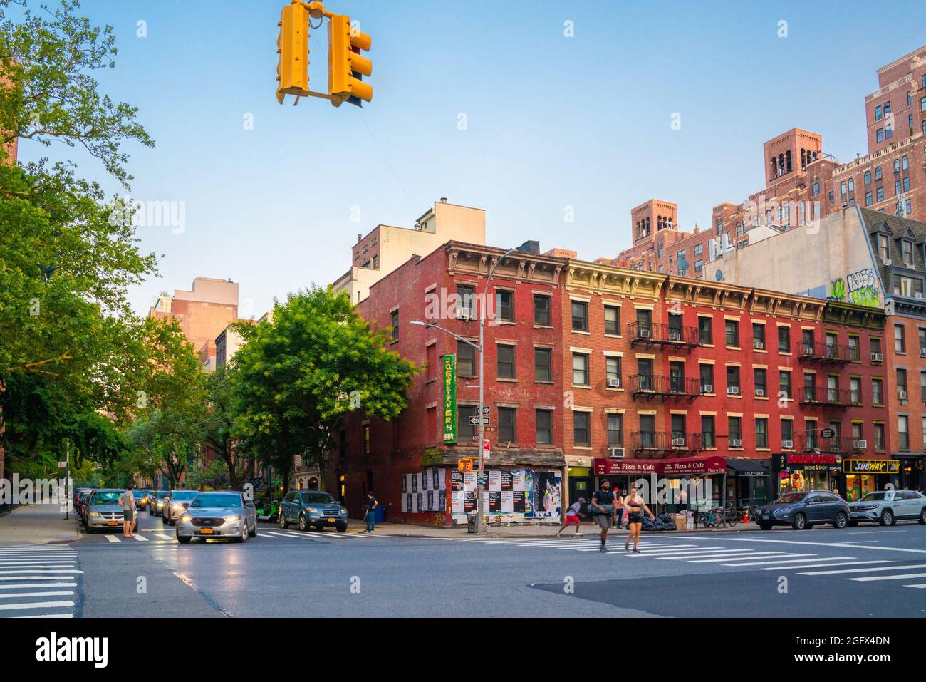 New York City, New York, USA - July 15, 2021:  Street scene from Chelsea neighborhood in Manhattan of intersection with people, buildings and cars. Stock Photo