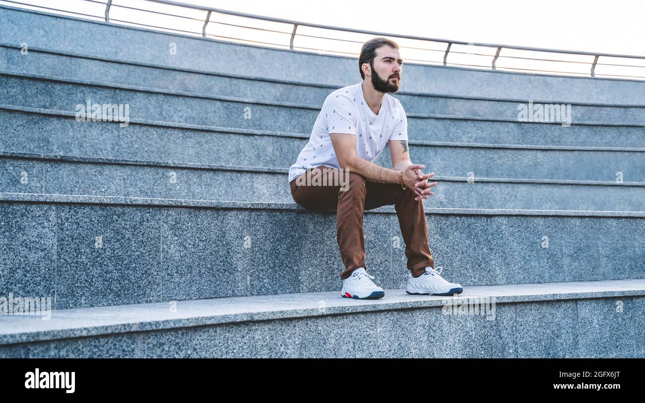 Lonely man sitting on stairs hi-res stock photography and images - Alamy